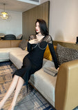 Full body view of the elegant black bodycon cocktail dress with long sleeves.