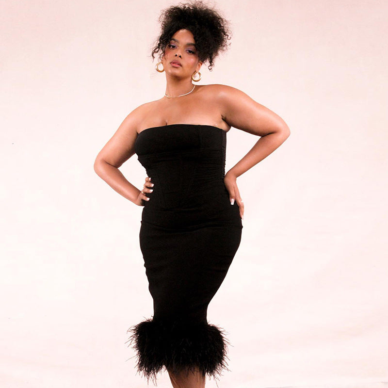 Close-up of the soft black feather hem on the strapless midi dress.