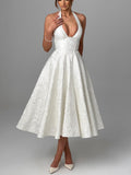 Elegant white fit and flare halter dress with a sculpted corset waist