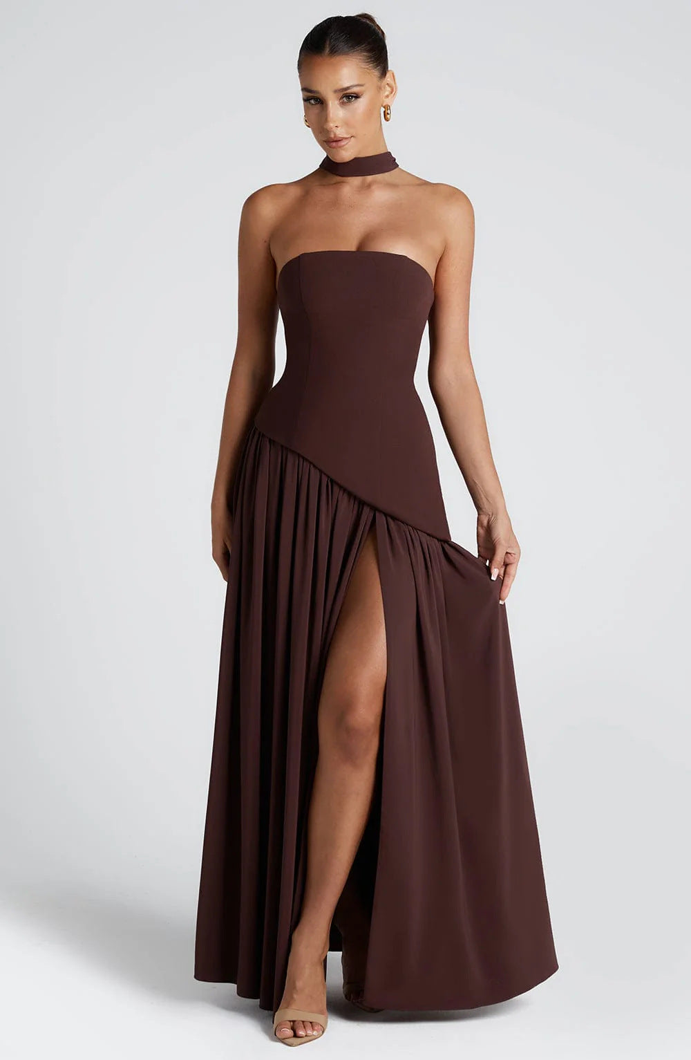 Front view of a woman in a dark brown sleeveless tube top evening gown.