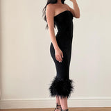 Side view of the formal black cocktail dress showing the feather detail.