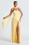 Woman posing in a strapless high slit formal maxi dress.