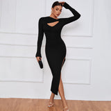Woman wearing a black long sleeve bodycon dress with a keyhole cutout and thigh-high slit.